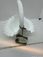 Top view of white milk glass basket showing ruffled rim and interior