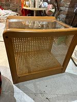 Angled front view showing rattan panel and wood frame