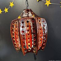 Full view of ceramic hanging lamp showing shape, glaze colours and chain