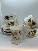 Group shot of cups stacked, saucers, and vase