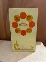 Front of cream colored Gilbert Microcraft microscope storage cabinet showing graphics