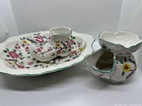 overview of three ceramics: bowl, boot vase, shaving mug