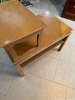 Pair of light maple Lane tiered side tables showing raised tier and lower shelf