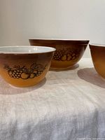 Three Pyrex Old Orchard bowls grouped showing sizes and design