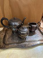 Full view of teapot, sugar bowl, creamer on tray
