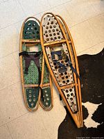 Both pairs of snowshoes side by side, full view