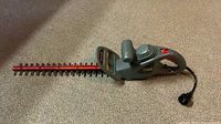 Entire hedge trimmer showing blade, body, and cord