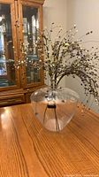 Full view of round clear glass vase on table