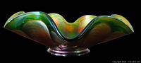 Side profile showing ruffled rim and iridescent finish