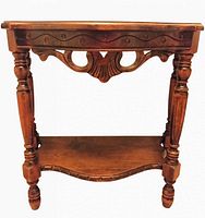 Front view of antique mahogany console table showing top, apron carving, legs and lower shelf