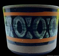 Front view showing geometric X-O motif and glaze colors