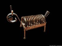 Side view of gold-tone coil spring animal letter holder