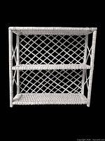 full front view of white wicker three-tier shelf