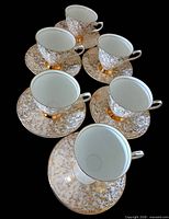 Six teacup and saucer sets arranged, showing overall quantity and pattern