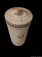 Full view of canister with lid showing Greek key border and laurel motif