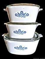 Stacked view of three CorningWare Blue Cornflower casseroles with lids