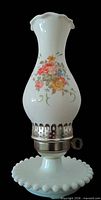 Full view of milk glass hurricane lamp showing floral chimney, metal collar, hobnail base