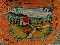 Close-up of needlepoint scene on pillow front