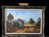 Full view of framed signed oil painting depicting barn landscape