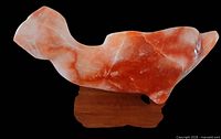 Left profile of whale sculpture on base
