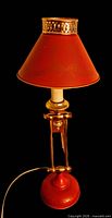 Full view of lamp showing shade, arm and base
