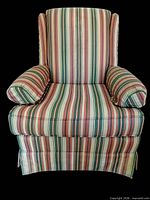 Front view of striped upholstered armchair showing overall design and skirted base