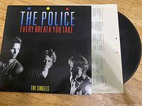 The Police Every Breath You Take The Singles vinyl record partially pulled from cover showing black record and white inner sleeve.