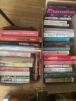 Two open boxes filled with assorted books showing visible titles and varying sizes