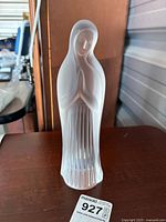 Front view of the 10-inch frosted glass figurine showing face, praying hands and draped cloak details.