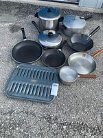 Overview of all pots and pans showing sizes, lids and grill pan