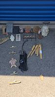 Overview of all items including three wind chimes and various small garden decor pieces on pavement