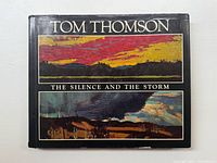 Front cover of the book showing the title and two landscape paintings by Tom Thomson in color.