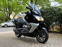 Front left view with headlights on, parked on driveway