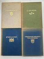 Four hardcover photographic art books with titled covers Frankreich, Canada, England, Vereinigte Staaten von Amerika arranged in a 2 by 2 grid.