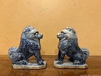 Side view of both figurines, one facing left and one facing right