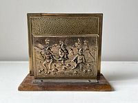 Overall front view of brass and wood letter holder