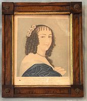 Front view of framed coloured engraving portrait of a young woman identified as Ninon Lenclos, showing the wood frame with decorative floral corner accents and gold inner trim, highlighting the detail of the woman's curls, flowers, pearl necklace, and blue garment.