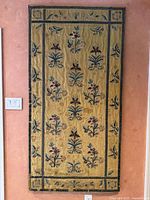 Full front view of the silk panel in its metal frame against a wall