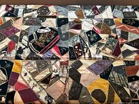 Overall view of irregular patchwork showing silk and cotton panels joined by decorative yellow embroidery.