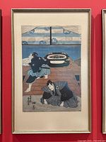 Framed woodblock print showing two figures indoors, overall view