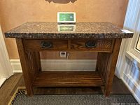 Front view of oak hall table with marble top