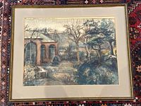 Full view of framed watercolor painting on patterned rug