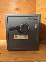 Front view of the gray Sentry Safe with digital keypad and black handle.