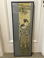 Full view of framed woodblock print showing vertical moonlit scene with two figures in traditional Japanese dress.