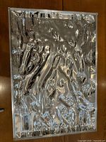 Full view of the rectangular clear acrylic tray with raised wavy textured surface.