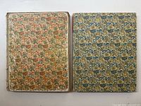 Two volumes side by side showing patterned covers