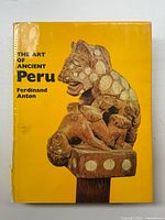 Front cover yellow dust jacket with sculpture image and book title/author text.