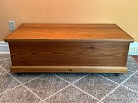 Front view of cedar chest showing honey-toned finish and simple panel design