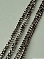 Close-up showing medium-sized curb links of the sterling silver chain