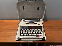 Front view of the Brother Echelon 89 typewriter inside its carrying case on a wooden surface, showing overall condition and case interior.